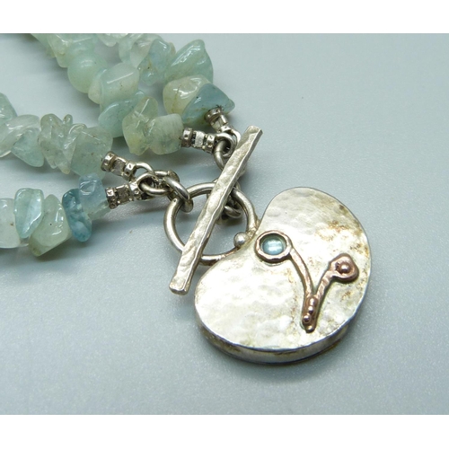 1090 - A silver pendant on a gem stone necklace