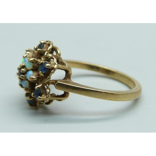 1111 - A 9ct gold cluster ring set with sapphires and opals, 2.5g, M