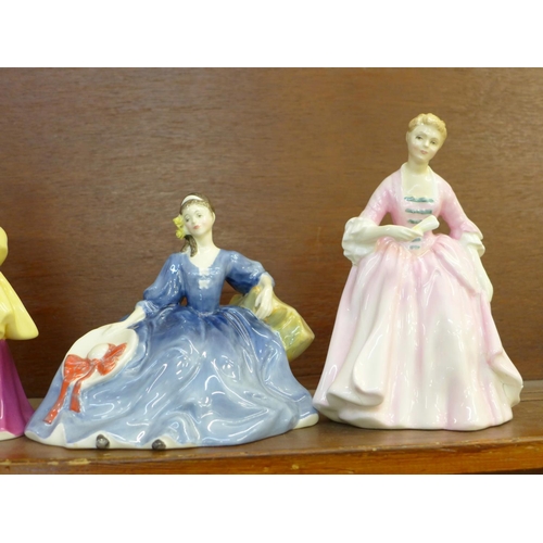 603 - Five Royal Doulton figures; Autumn Breezes, Hilary, Loretta, The Hostess of Williamsburg, a/f, and E... 