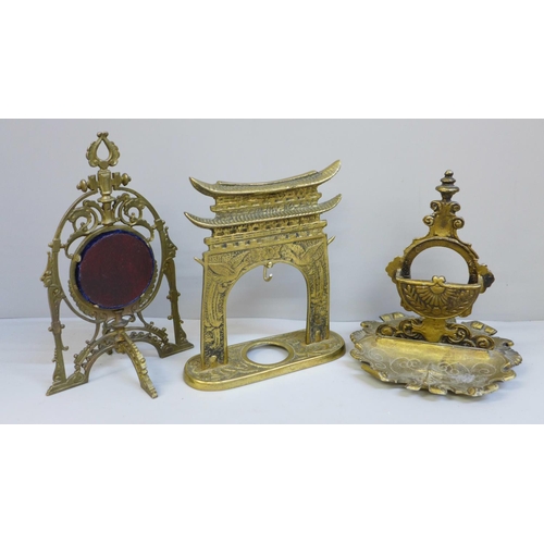 631 - Three watch stands including one in the form of an oriental gate