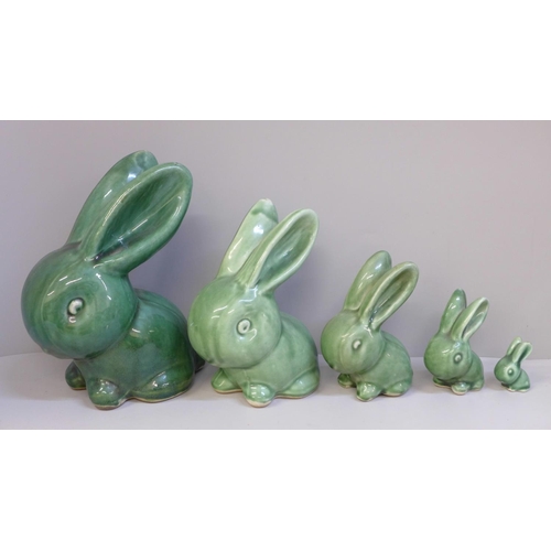 646 - A graduated set of five Bourne Denby rabbits with glossy green glaze