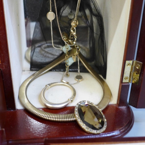 695 - A jewellery case with Envy necklace, Argento necklace, watch, costume jewellery, etc.