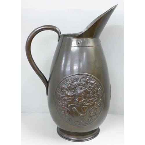 785 - A circa 1900 large copper jug with coat of arms and tavern scene, 47cm