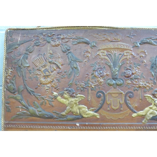 806 - A leather panel of cherubs, 85cm x 45cm