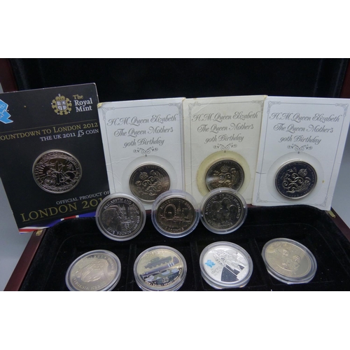 830 - Nineteen commemorative £5 coins, in a box