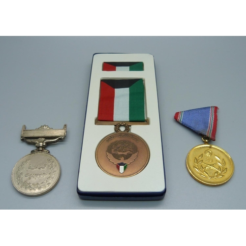 860 - A Liberation of Kuwait medal, Pakistan Democracy medal and a Hungarian medal