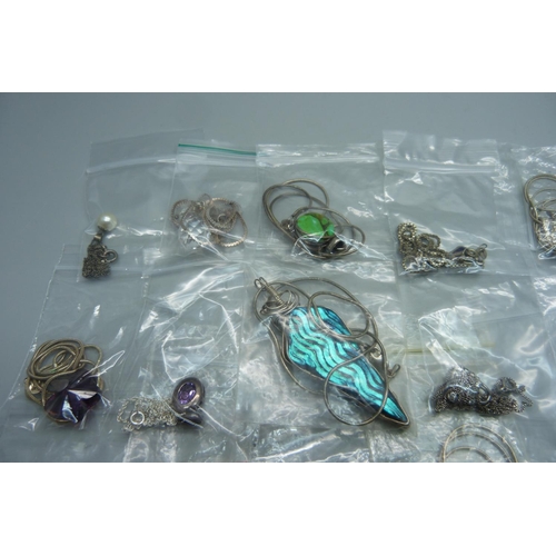 883 - A collection of silver pendants and chains