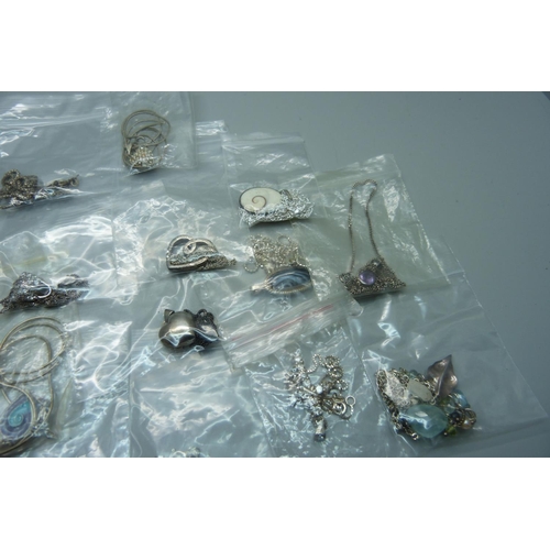 883 - A collection of silver pendants and chains