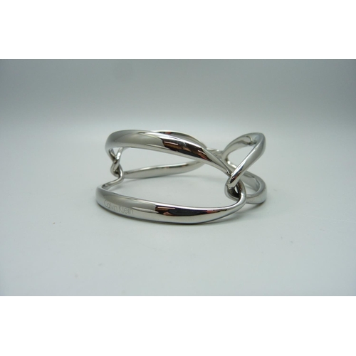 889 - A Calvin Klein silvertone segment link bracelet, boxed