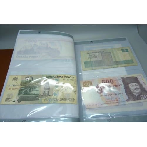 927 - An album of British and foreign bank notes, 10 shillings notes, US dollars, etc.