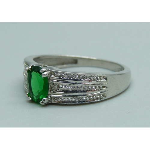 928 - A 9ct white gold and green stone ring, 3.2g, O