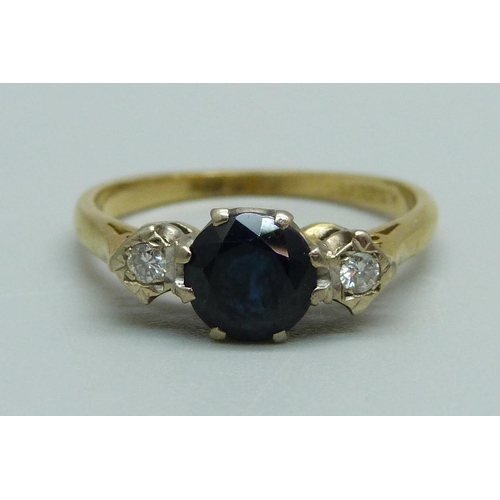 932 - An 18ct gold, diamond and sapphire three stone ring, 3.2g, O