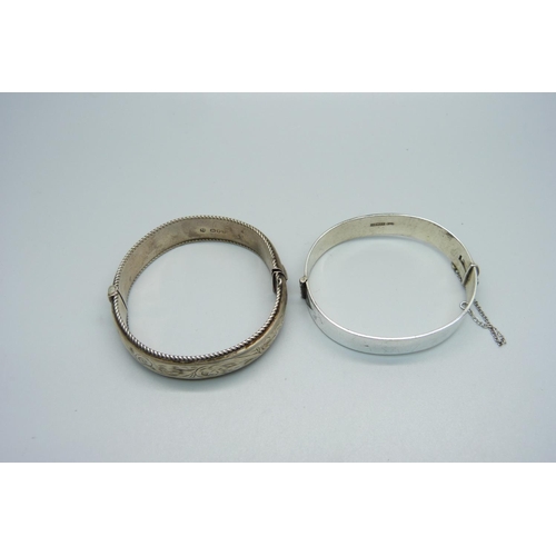 965 - Two silver bangles, one dented, 55g