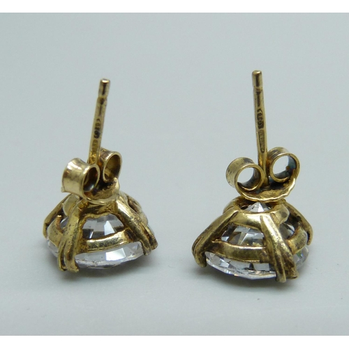 989 - A pair of silver gilt and diamond simulant ear studs