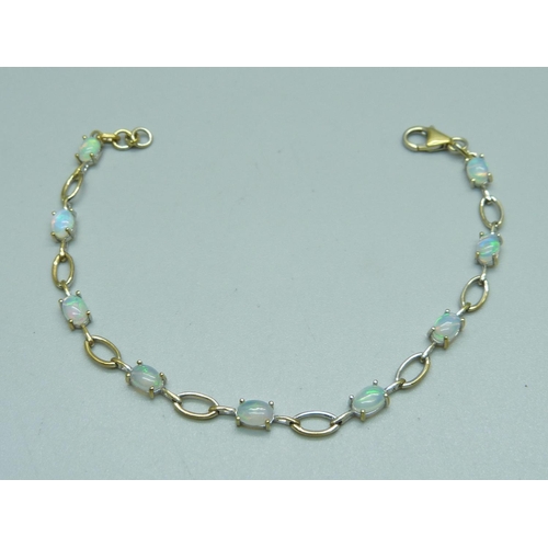 991 - A silver gilt Ethiopian opal tennis bracelet, opal weight approximately 3.10ct