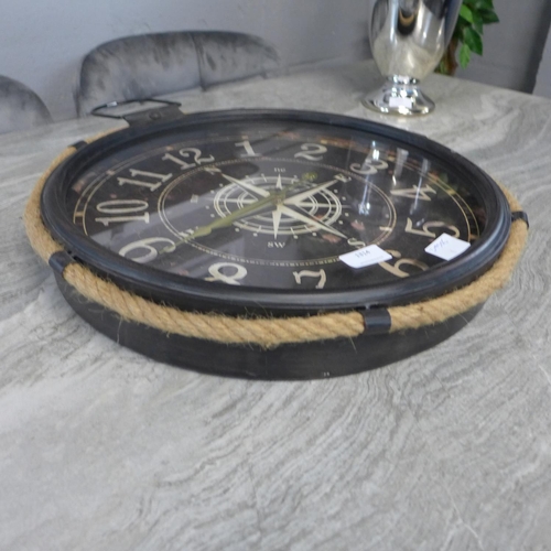 1314 - A black metal and rope industrial style clock depicting a compass