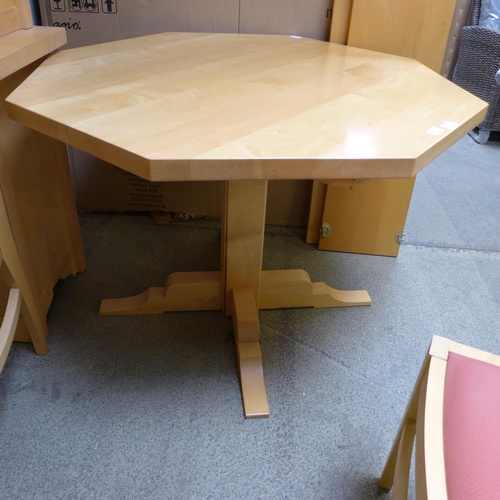 1581 - A birch octagonal extending dining table and four red upholstered birch dining chairs by Collis King... 
