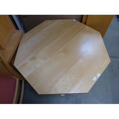 1581 - A birch octagonal extending dining table and four red upholstered birch dining chairs by Collis King... 