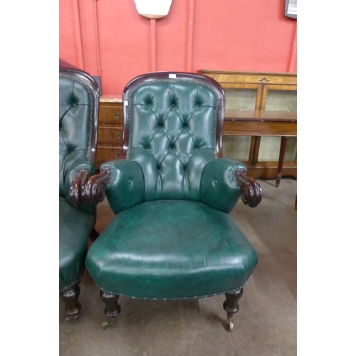 134 - A pair of Victorian mahogany and green leather upholstered armchairs