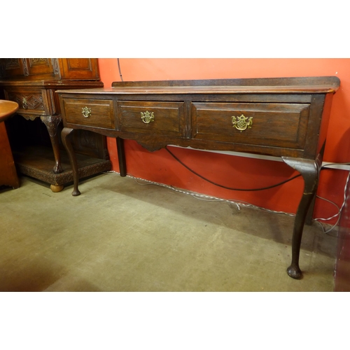 135 - A George II style oak three drawer dresser