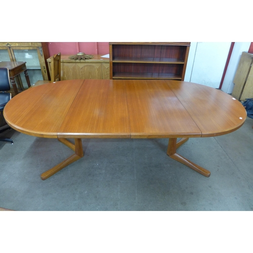 14 - A Danish teak extending dining table