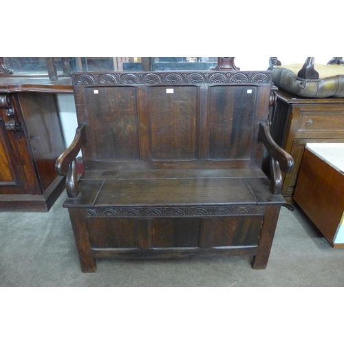 144 - A 17th Century style carved oak hall seat