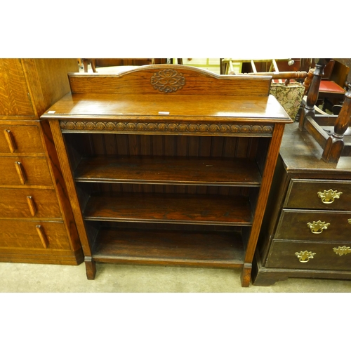 150 - A carved oak open bookcase