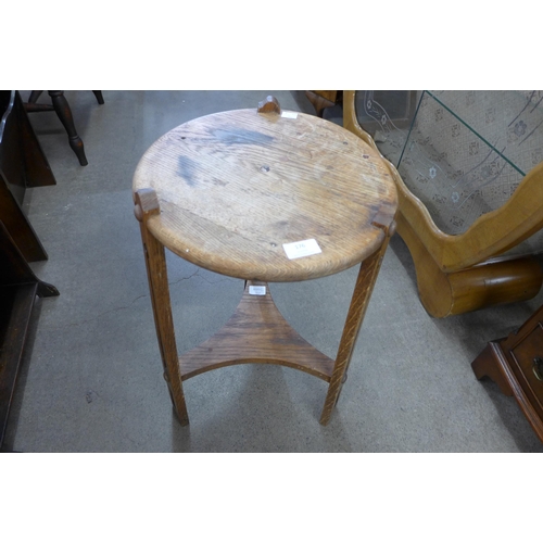 176 - An Arts and Crafts oak circular occasional table