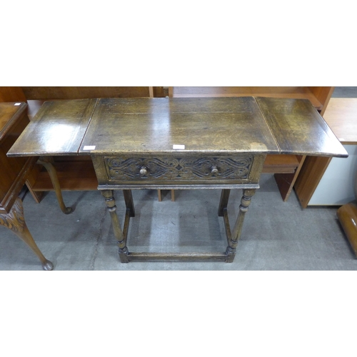 206 - A 17th Century style carved oak single drawer drop leaf side table