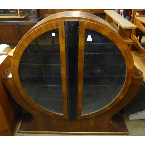 219 - An Art Deco walnut two door circular display cabinet