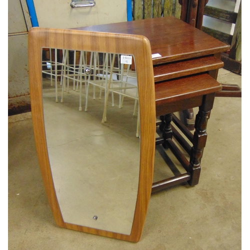 261 - A simulated teak framed mirror and an oak nest of tables