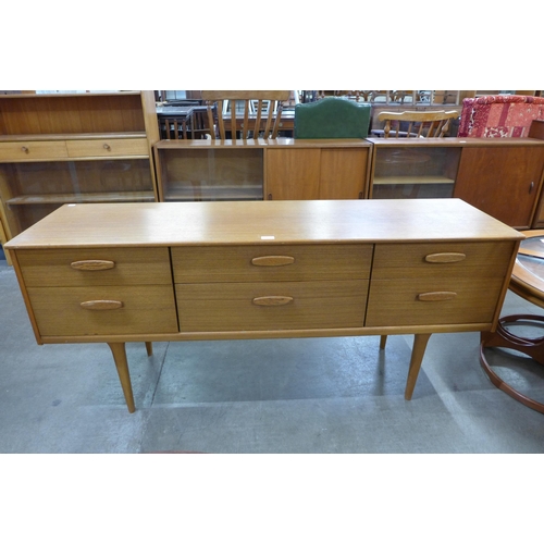 29 - An Austin Suite teak six drawer sideboard