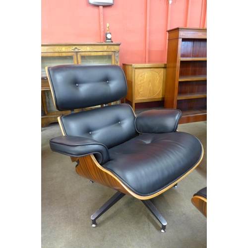 35 - A Charles & Ray Eames style simulated rosewood and black leather revolving lounge chair and ottoman