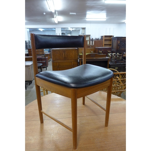 46 - A McIntosh teak circular extending dining table and four chairs