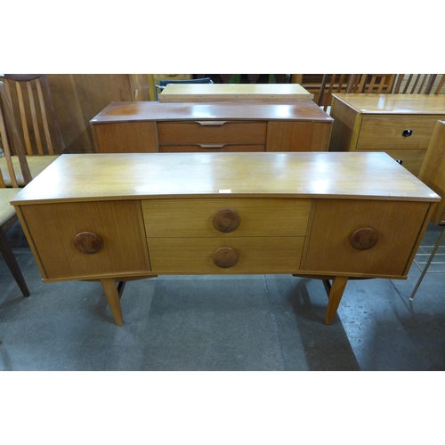 50 - A teak concave sideboard