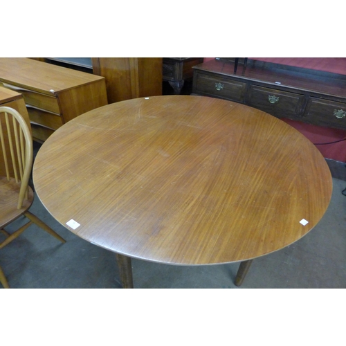 56 - A teak circular dining table