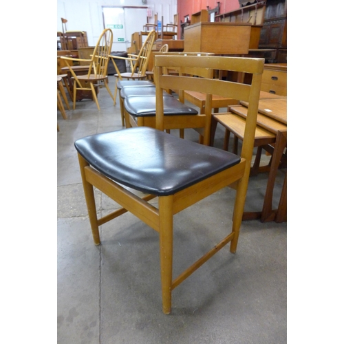 57 - A set of four teak dining chairs