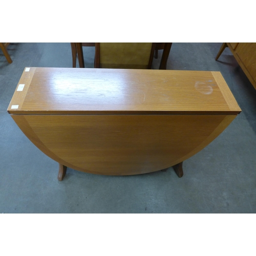 62 - A teak drop-leaf table