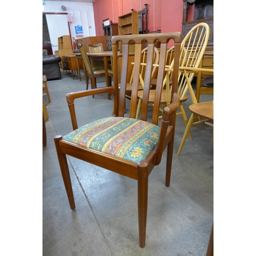 65 - A set of four teak dining chairs