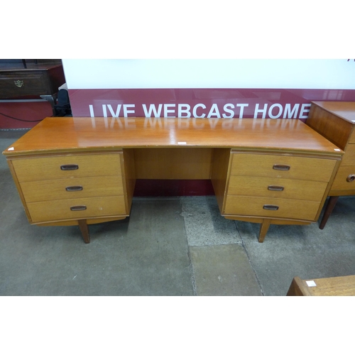 7 - A teak concave desk