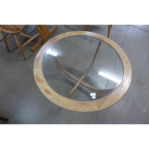 8 - A G-Plan Astro teak and glass topped circular coffee table