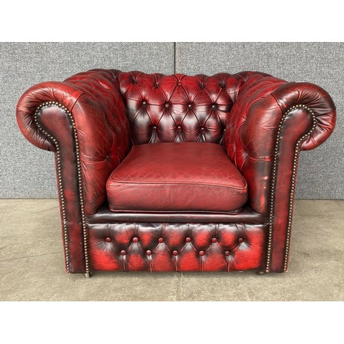 119 - An oxblood red leather Chesterfield club chair