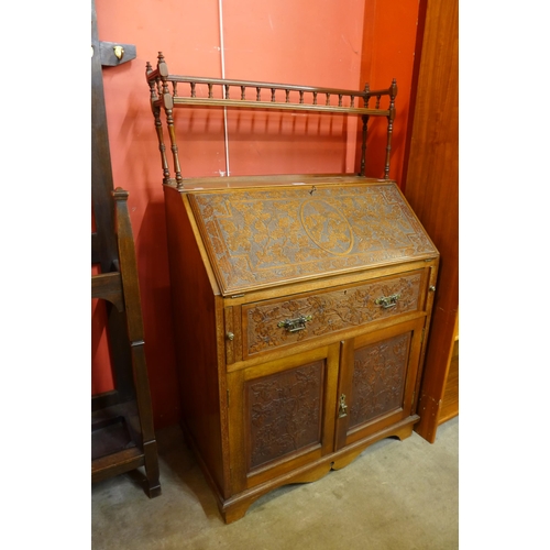 116 - A Victorian Aesthetic Movement carved walnut bureau