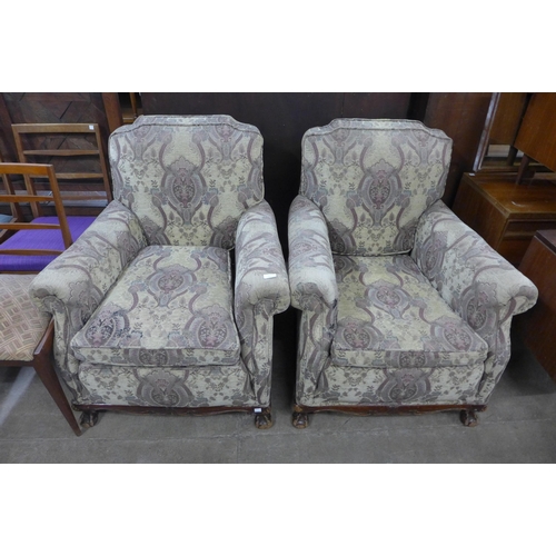 218 - A pair of early 20th Century Chippendale Revival carved mahogany and fabric upholstered armchairs