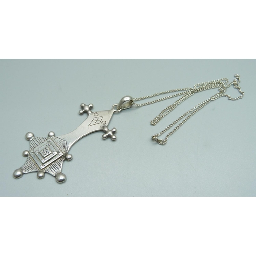 1006 - A silver coptic cross pendant on a silver chain, cross 39mm wide