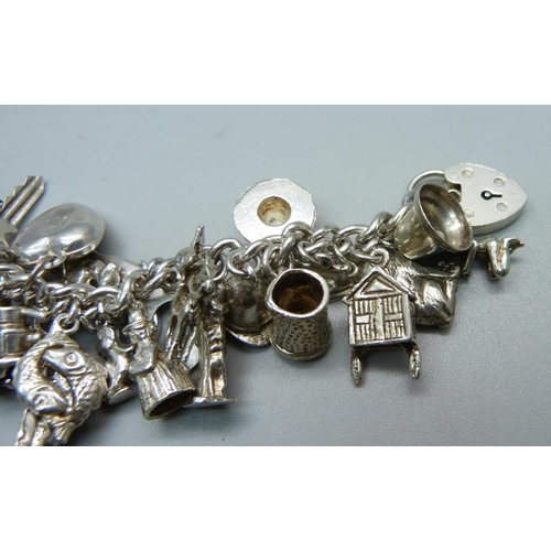 1008 - A silver charm bracelet, 120g