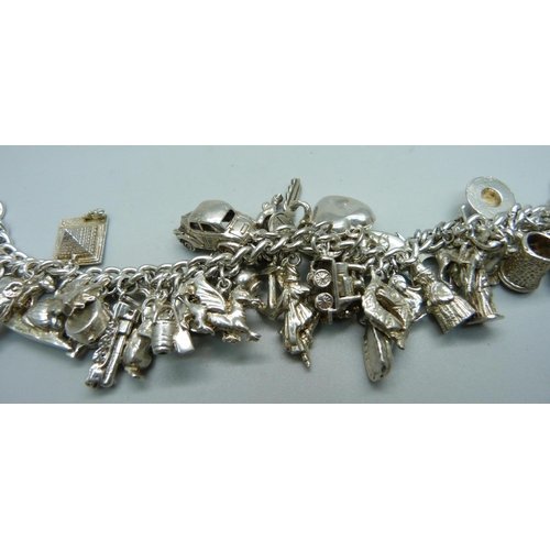 1008 - A silver charm bracelet, 120g