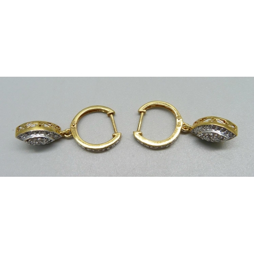 1014 - A pair of silver gilt and diamond drop earrings