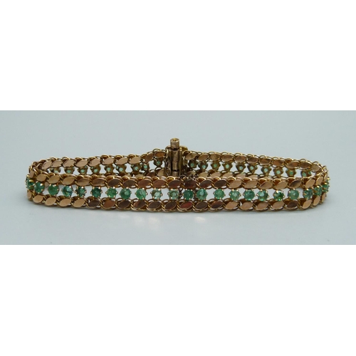 1017 - A 14k gold and forty-six emerald bracelet, 11.9g, marked 14 and 585, 18cm