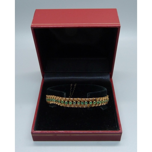 1017 - A 14k gold and forty-six emerald bracelet, 11.9g, marked 14 and 585, 18cm